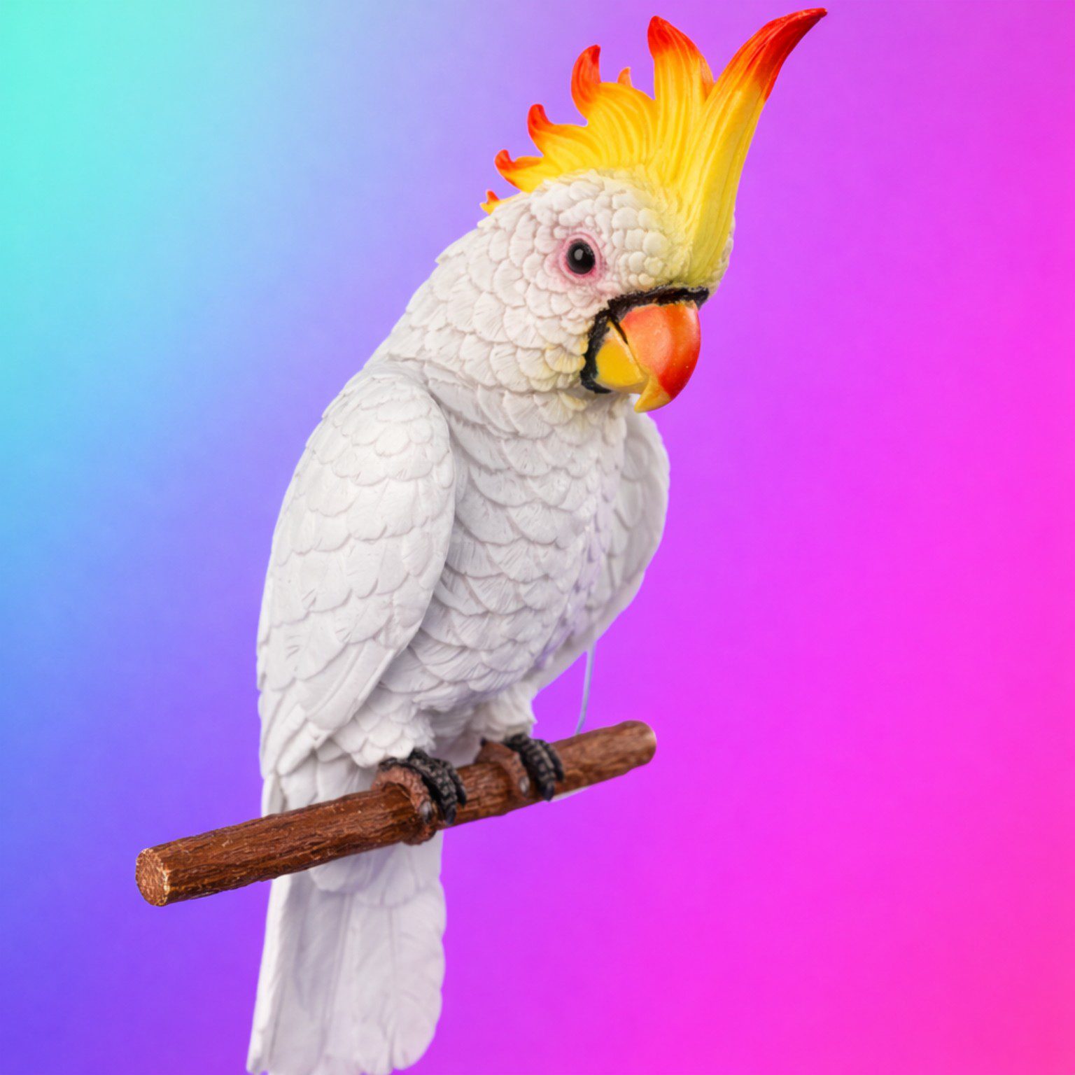 A White cockatoo with yellow crest on perch.