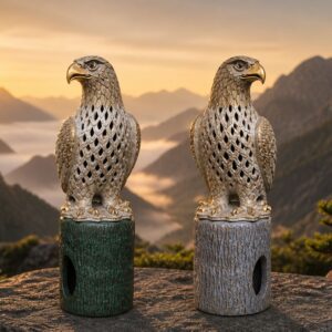 Two ornate eagle statues at mountain sunrise