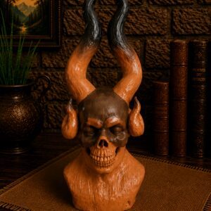 Orange horned skull bust on table