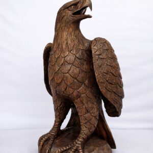 Carved wooden eagle sculpture on rock base